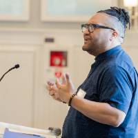 Dr. Shorty standing at podium, speaking at event